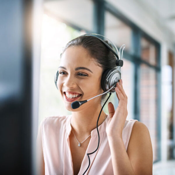 a female tech support agent smiles as she helps a client