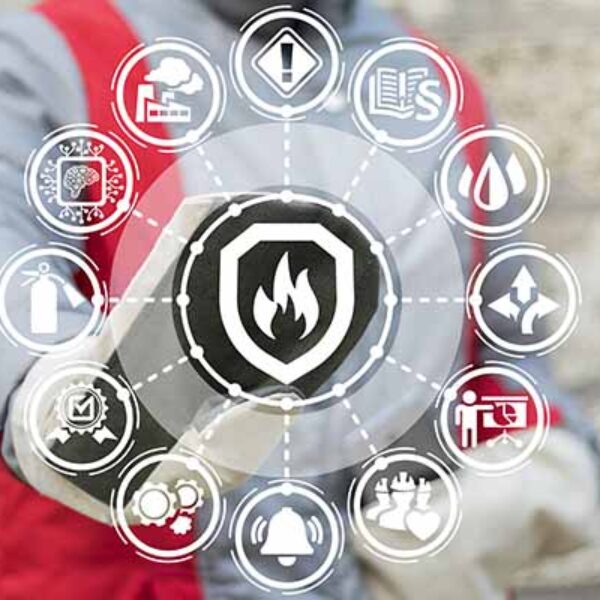 A person wearing protective gear interacts with a digital grid of safety icons, including fire prevention, hazard alerts, safety procedures, and emergency equipment symbols. The icons are arranged in a circular pattern around a central shield with a flame symbol.